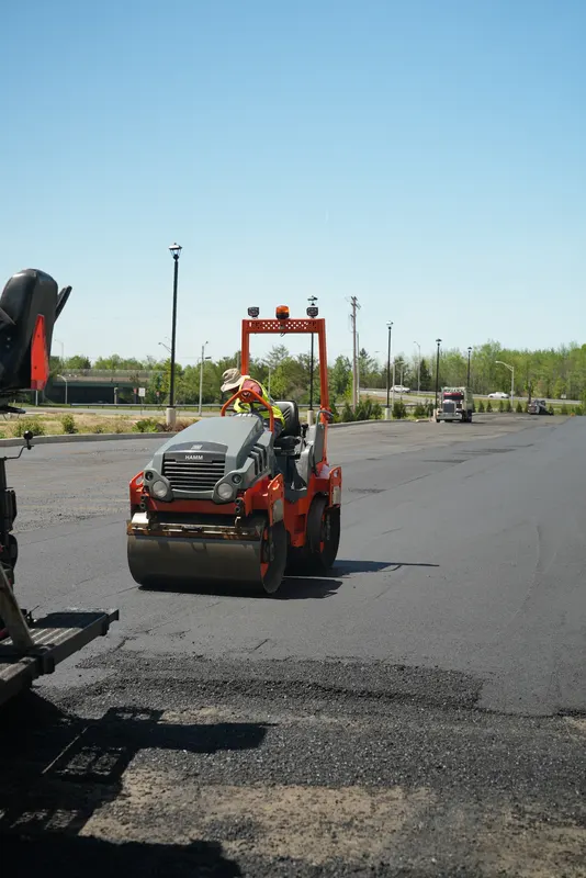 Roller compacting fresh asphalt on a parking lot