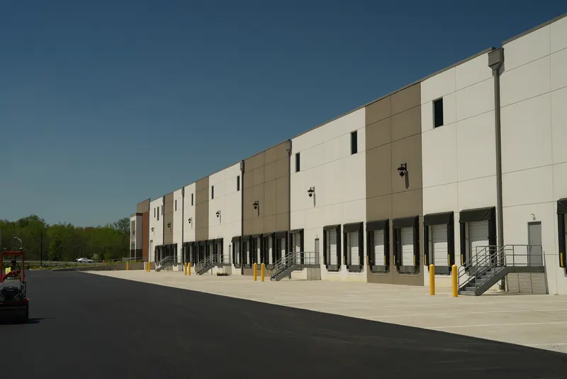 Finished asphalt parking lot running the length of a warehouse