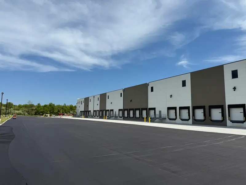 New asphalt parking lot beside a warehouse with loading docks in New Jersey
