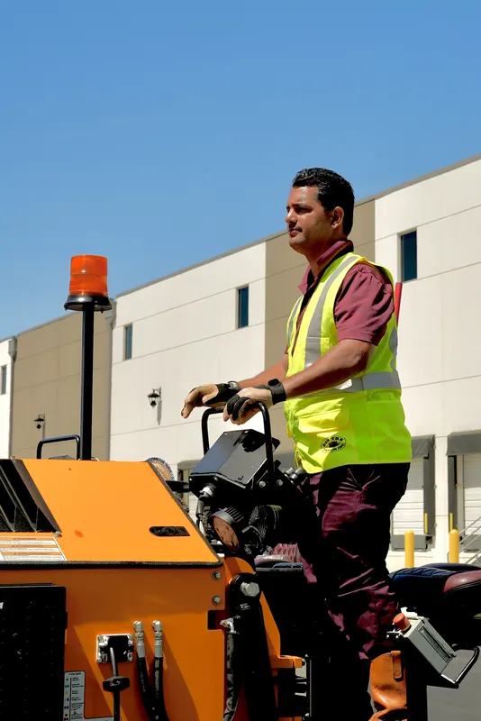 Dan The Paver crew member at the controls of the paving machine