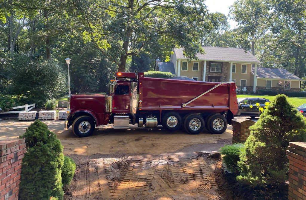 Dan the Paver team working together on asphalt paving for a residential driveway.